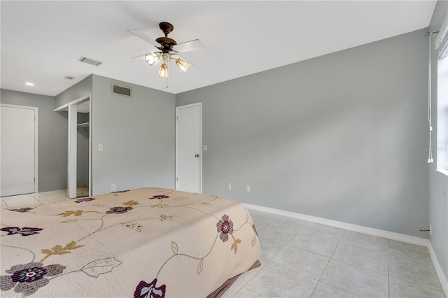 unfurnished bedroom with ceiling fan, a closet, and light tile patterned floors