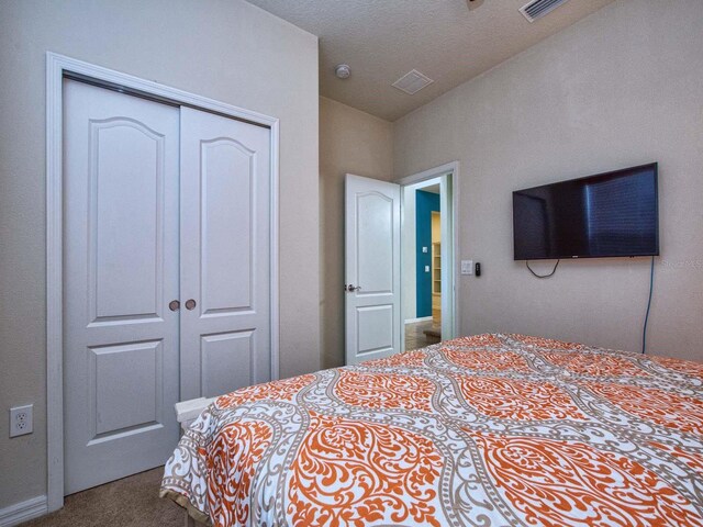 bedroom featuring a closet and carpet flooring