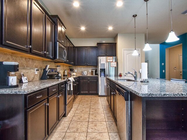 kitchen featuring light stone counters, light tile patterned floors, backsplash, and stainless steel appliances