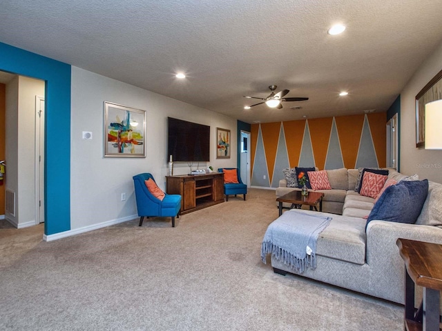 carpeted living room featuring a textured ceiling and ceiling fan