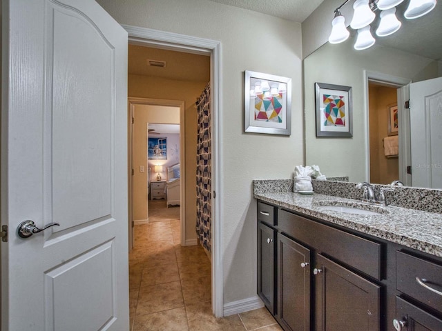 bathroom with tile patterned flooring and vanity