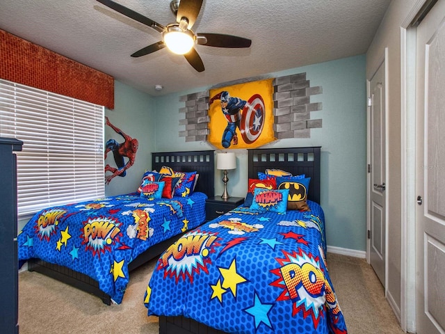 carpeted bedroom featuring a textured ceiling and ceiling fan