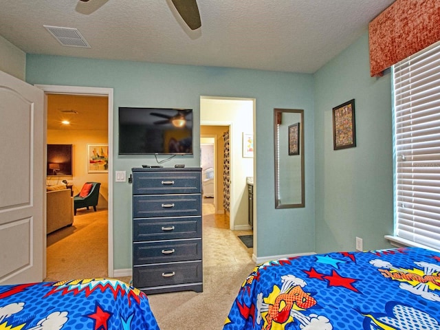 bedroom with light carpet, a textured ceiling, and ceiling fan