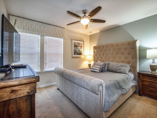 bedroom with light carpet and ceiling fan