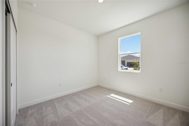 unfurnished bedroom featuring baseboards and carpet flooring