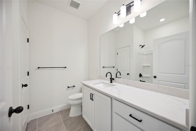 bathroom with visible vents, baseboards, toilet, tile patterned flooring, and vanity