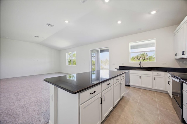 kitchen with lofted ceiling, dark countertops, visible vents, electric range oven, and dishwasher