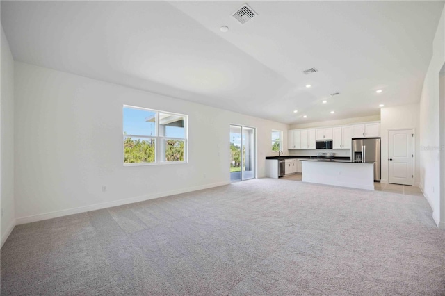 unfurnished living room with light carpet, recessed lighting, and baseboards