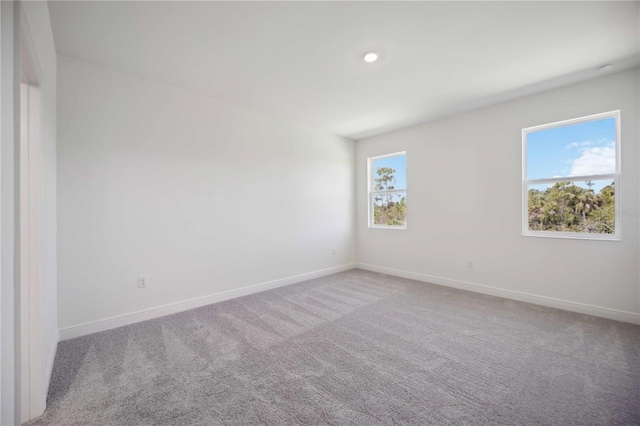 empty room with recessed lighting, carpet flooring, and baseboards