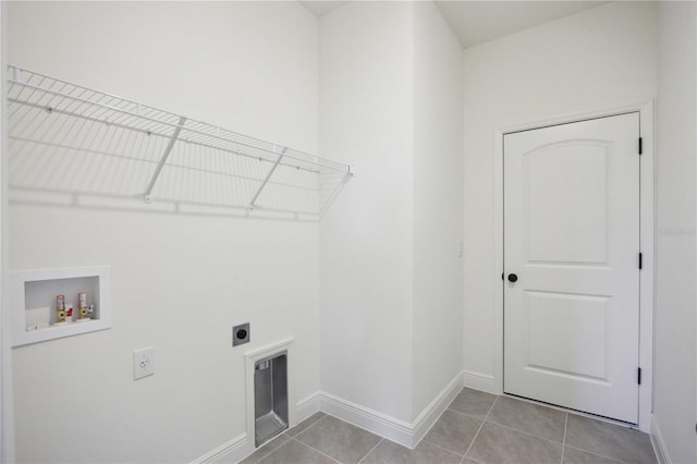 laundry area featuring laundry area, baseboards, tile patterned floors, hookup for a washing machine, and electric dryer hookup