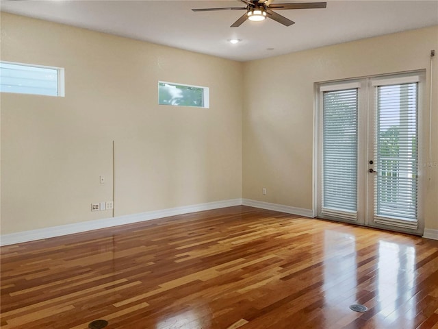 unfurnished room featuring french doors, hardwood / wood-style flooring, and ceiling fan