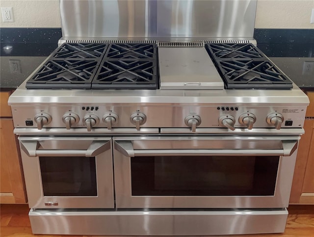 room details with stone counters and double oven range