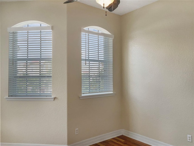 spare room with hardwood / wood-style flooring, ceiling fan, and a wealth of natural light