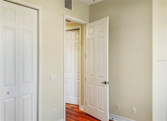 unfurnished bedroom with hardwood / wood-style floors and a closet