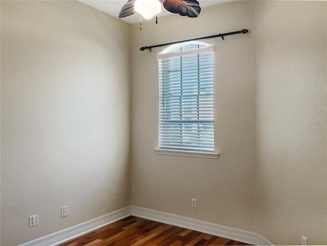 spare room featuring ceiling fan and dark hardwood / wood-style floors