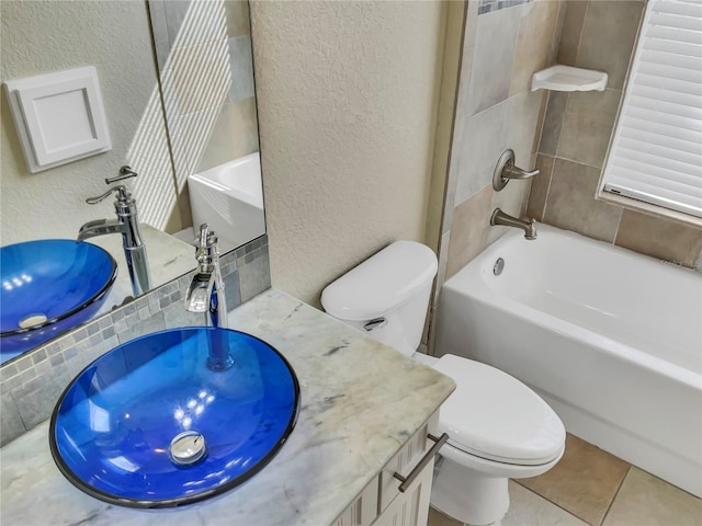 full bathroom with tile patterned flooring, vanity, toilet, and tiled shower / bath