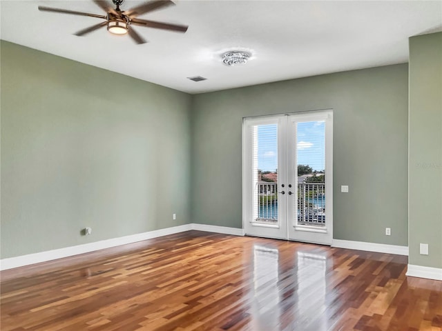 unfurnished room featuring hardwood / wood-style floors, ceiling fan, and french doors