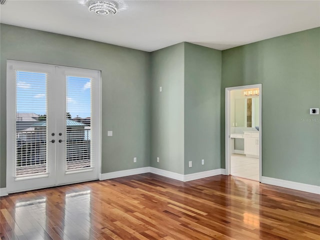 unfurnished room with french doors and wood-type flooring