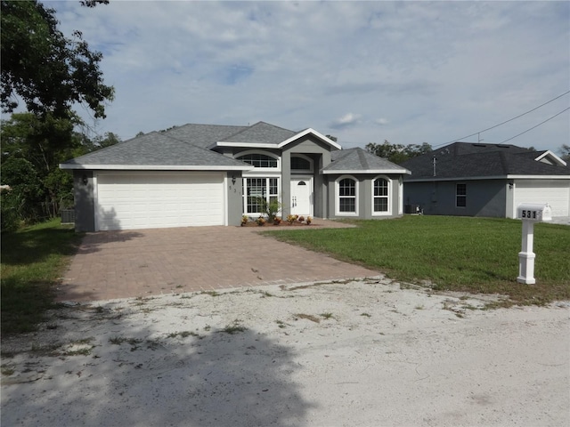 ranch-style house featuring a front yard and a garage