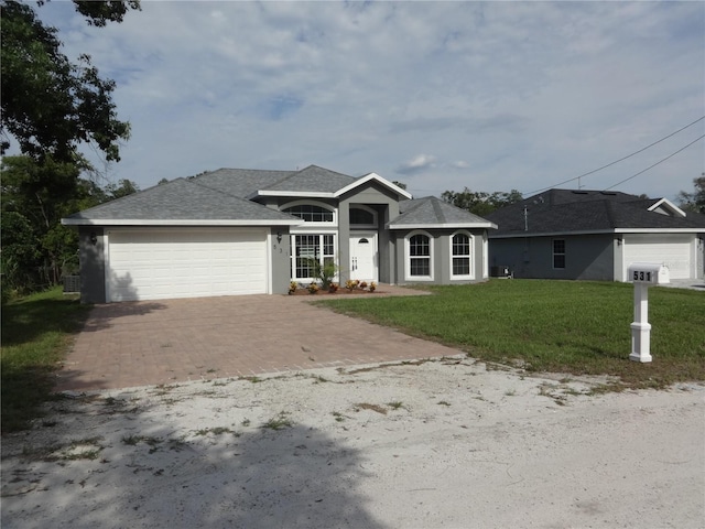 ranch-style home featuring a front yard and a garage