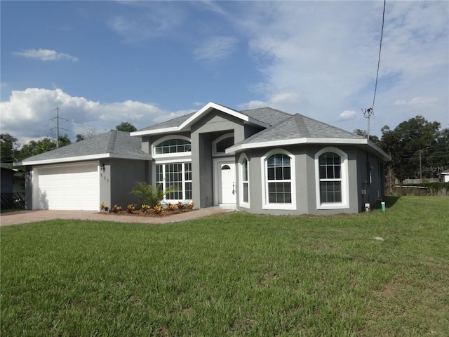 ranch-style home with a garage and a front lawn