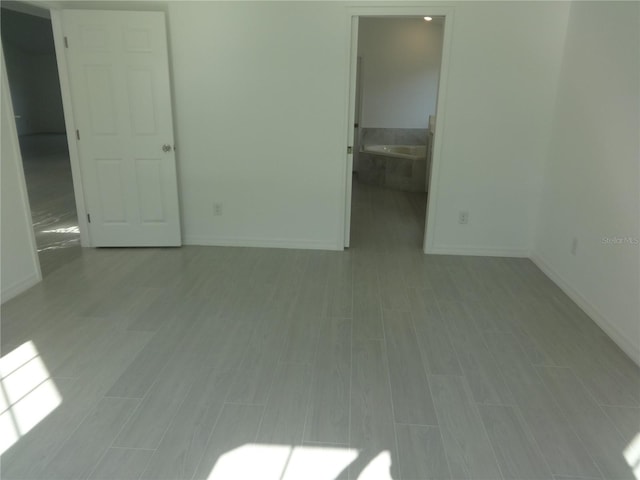 empty room with light hardwood / wood-style flooring