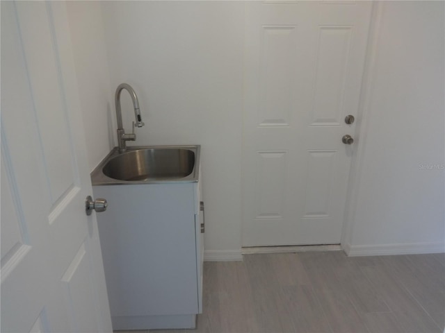 531 Rhodes Dr, Deland, FL 32720 - laundry area with a sink and light wood-style floors
