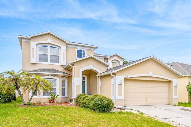 front facade featuring a garage and a front yard