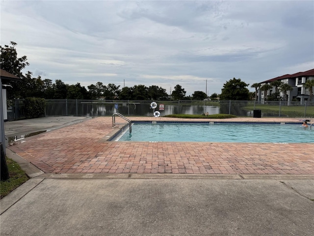 view of swimming pool with a water view