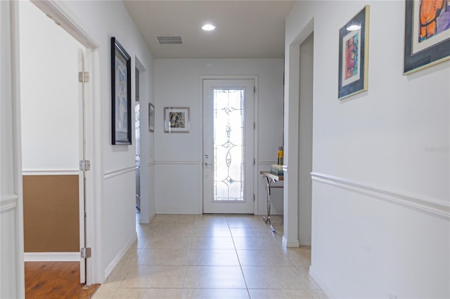 tiled entryway with a healthy amount of sunlight