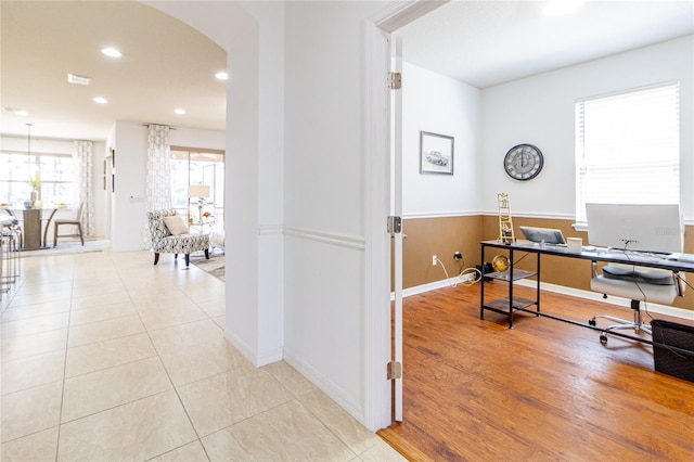 office featuring wooden walls and light tile patterned flooring