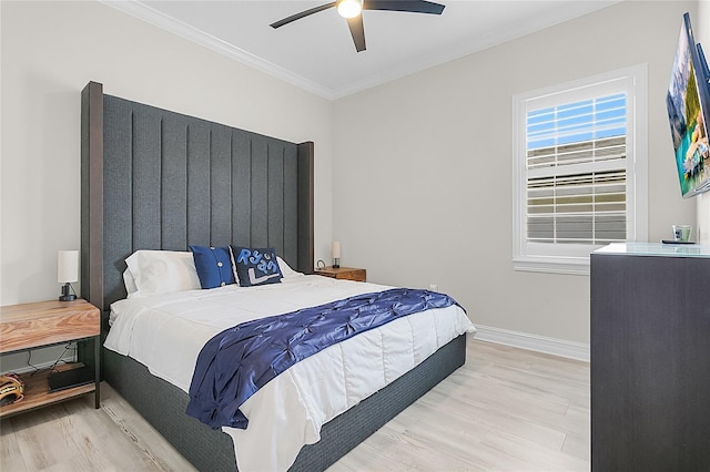 bedroom with light wood-type flooring, ceiling fan, and ornamental molding