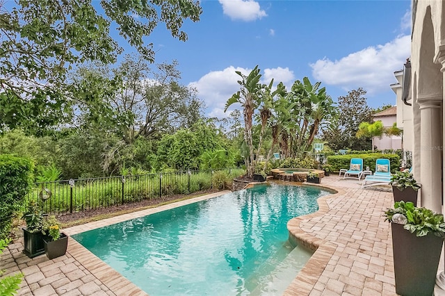 view of pool with an in ground hot tub and a patio