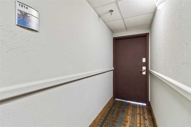 doorway to outside featuring a paneled ceiling