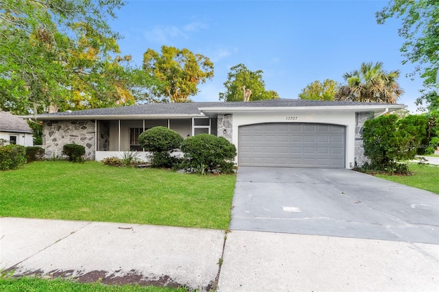 single story home featuring a garage and a front lawn