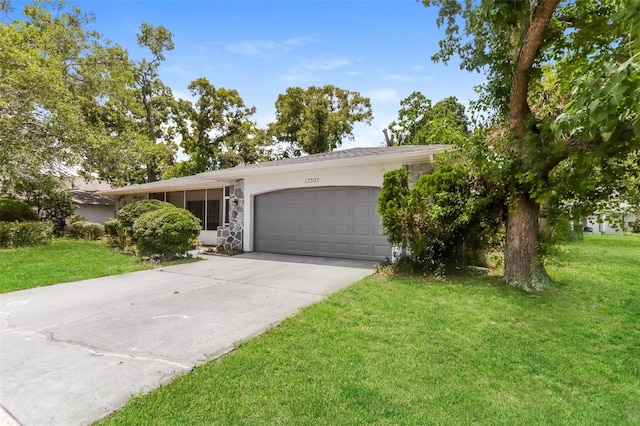 single story home featuring a garage and a front lawn