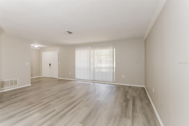 empty room with light hardwood / wood-style floors