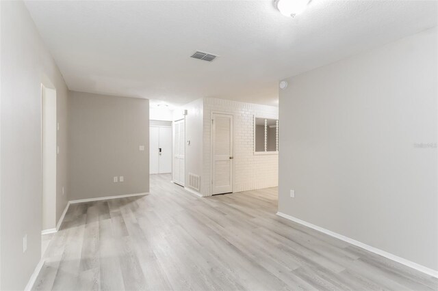 unfurnished room with light hardwood / wood-style flooring