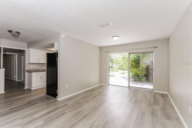 unfurnished room with hardwood / wood-style floors