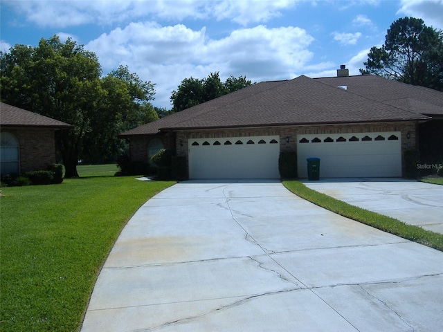 ranch-style home featuring a garage and a front lawn