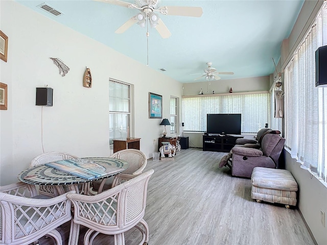 interior space featuring a wealth of natural light, ceiling fan, and light hardwood / wood-style flooring