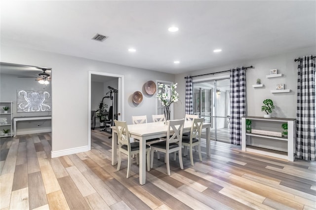 dining space with light hardwood / wood-style floors and ceiling fan