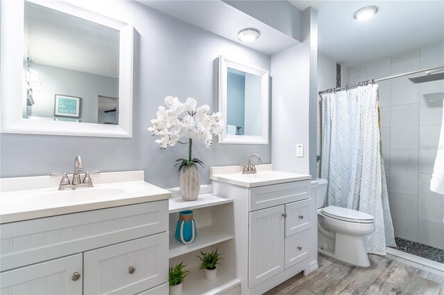 bathroom with hardwood / wood-style flooring, toilet, vanity, and a shower with shower curtain