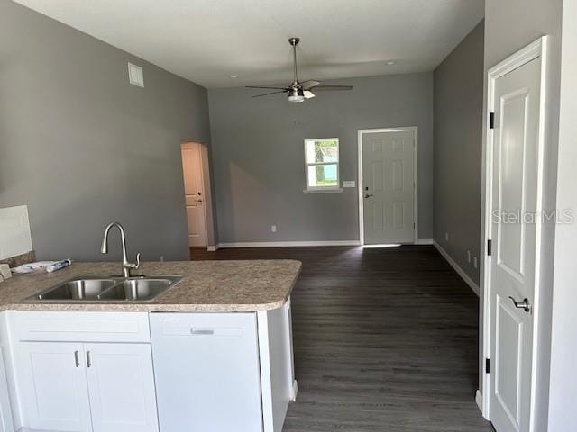 kitchen with white dishwasher, ceiling fan, dark wood-type flooring, white cabinets, and sink