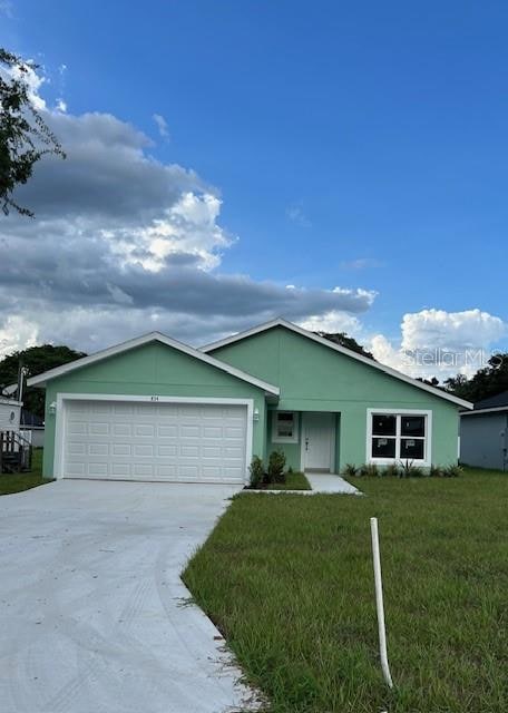 ranch-style home with a front yard and a garage