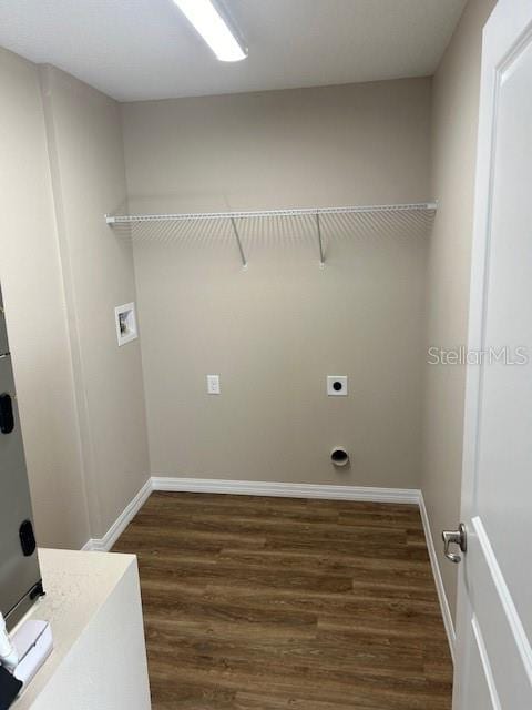 washroom featuring electric dryer hookup, dark wood-type flooring, and washer hookup