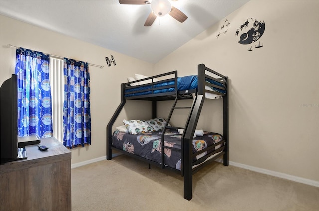 carpeted bedroom featuring ceiling fan and vaulted ceiling