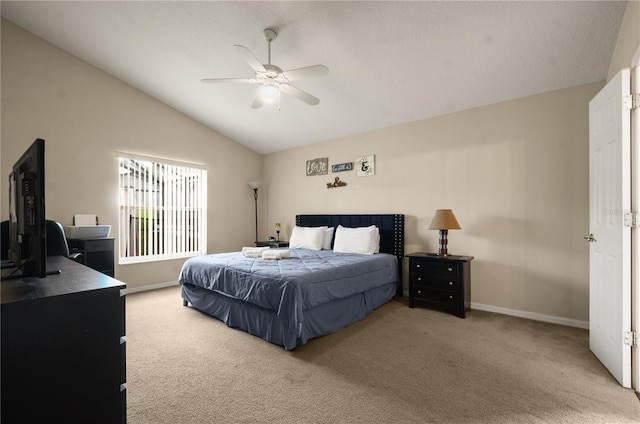 carpeted bedroom featuring ceiling fan and vaulted ceiling