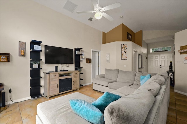 living room with ceiling fan, vaulted ceiling, and light tile patterned floors