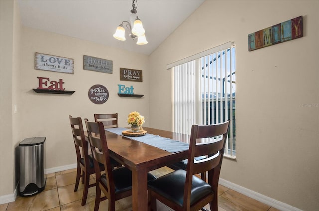 dining room featuring tile patterned floors, vaulted ceiling, a notable chandelier, and a wealth of natural light